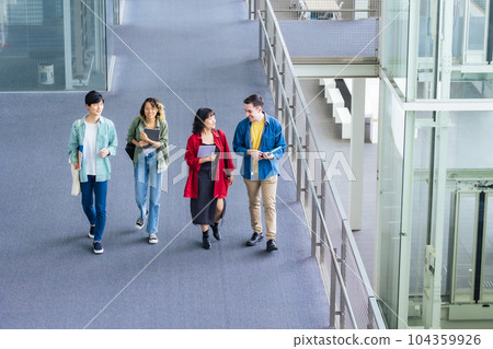 Multinational youth group walking in lobby 104359926