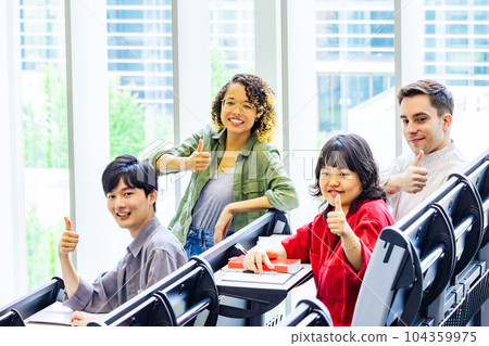 Group of multinational students thumbing up in classroom 104359975