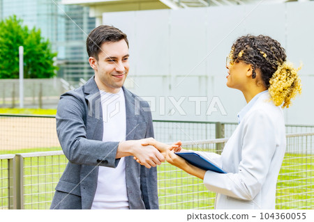 Foreigner group shaking hands outdoors Foreigner group shaking hands outdoors 104360055