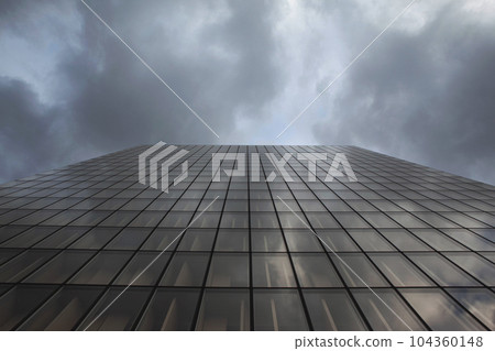 Glass building and stormy cloudy sky 104360148