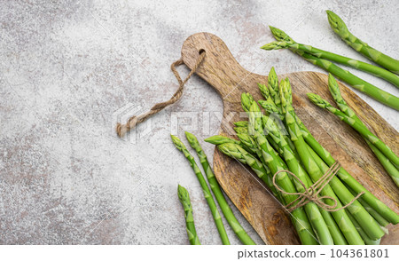 Fresh green asparagus on concrete background. Fresh green asparagus on concrete background. 104361801