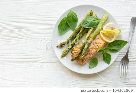 Baked Delicious salmon, green asparagus on  plate 104361809