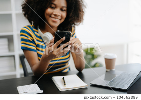 businesswoman hand using smart phone, tablet payments and holding credit card online shopping, omni channel, digital tablet docking keyboard computer at office 104362889
