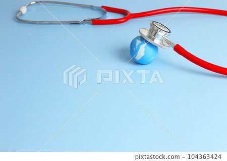 Checking health with red stethoscope on earth. World health day concept - blue earth with on light blue background 104363424