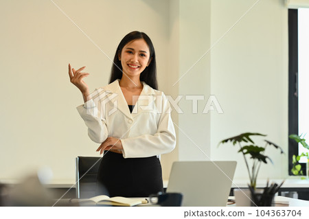 Confident asian woman team leader giving presenting new marketing strategy at corporate meeting Confident asian woman team leader giving presenting new marketing strategy at corporate meeting 104363704