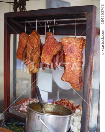 Barbecued red pork and crispy pork  in street food market . 104363768