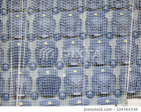 Spectator and fan seats in the tribunes of the sports hall 104364336