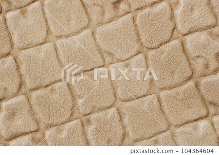 Closeup on leather texture surface with diagonal squre stamped pattern. Modern background Closeup on leather texture surface with diagonal squre stamped pattern. Modern background 104364604