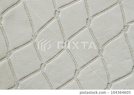 Genuine leather with rhombus embossed pattern. Modern pattern, background Genuine leather with rhombus embossed pattern. Modern pattern, background 104364605