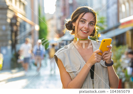 Tourist traveler woman girl using looking smartphone search a way on map in mobile navigator app 104365079