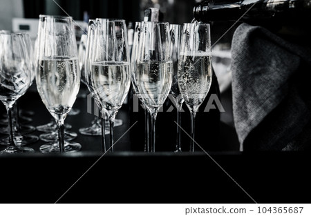 waiter pours wine and champagne waiter pours wine and champagne 104365687