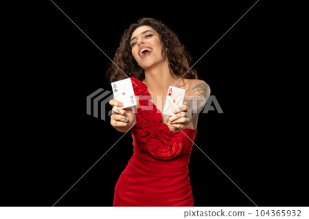 Lucky excited girl poker player showing winning pair of aces Lucky excited girl poker player showing winning pair of aces 104365932