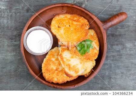 Belarusian cuisine. Potato draniki stew with sour cream 104366234
