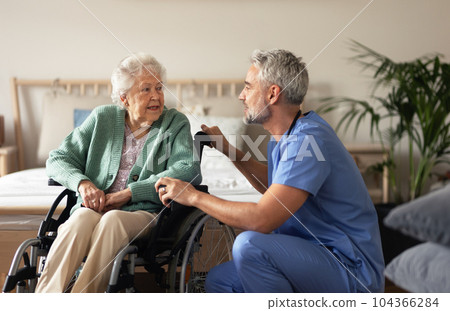 Caregiver doing regular check-up of senior woman in her home. Caregiver doing regular check-up of senior woman in her home. 104366284