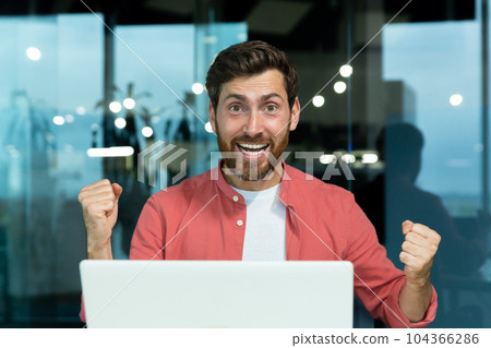 Portrait of successful businessman inside office at workplace, satisfied with achievement results man smiling and looking at camera, holding hands up celebrating victory and triumph. Portrait of successful businessman inside office at workplace, satisfied with achievement results man smiling and looking at camera, holding hands up celebrating victory and triumph. 104366286