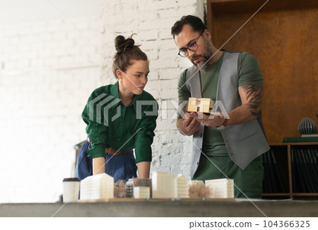 Young couple working as architects in the office. Young couple working as architects in the office. 104366325