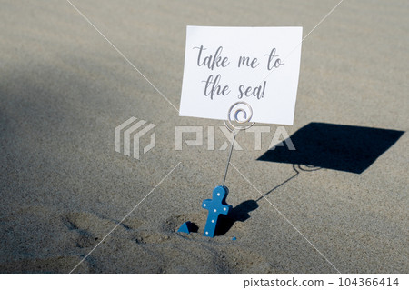 TAKE ME TO THE SEA text on paper greeting card in anchor paper holder and starfish seashell summer vacation decor. Sandy beach sun coast. Holiday concept postcard. Getting away Travel TAKE ME TO THE SEA text on paper greeting card in anchor paper holder and starfish seashell summer vacation decor. Sandy beach sun coast. Holiday concept postcard. Getting away Travel 104366414