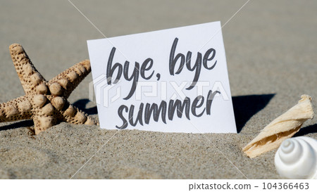 BYE BYE SUMMER text on paper greeting card on background of starfish seashell summer vacation decor. Sandy beach sun coast. Holiday concept postcard. Getting away Travel 104366463