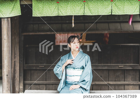 A young woman wearing a green curtain and Japanese clothes 104367389