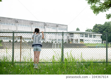Children looking at school from outside the fence Children looking at school from outside the fence 104367814