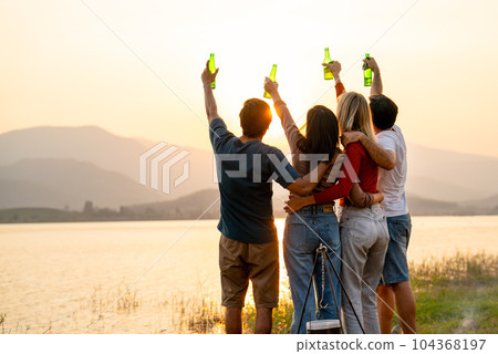 Wide shot of Back of group of friends with multi-ethnic hug together also hold bottle of drinking 104368197