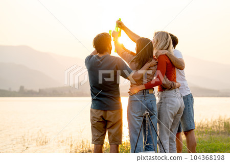 Back of group of friends with multi-ethnic hug together also hold bottle of drinking Back of group of friends with multi-ethnic hug together also hold bottle of drinking 104368198