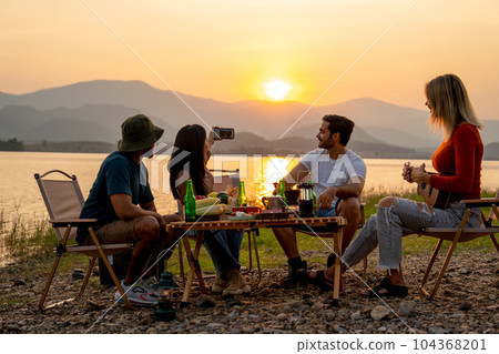 Beautiful Asian woman use mobile phone to selfie with her friends during camping and enjoy together Beautiful Asian woman use mobile phone to selfie with her friends during camping and enjoy together 104368201