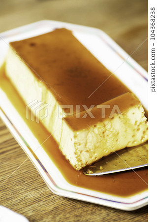 Separate a large pudding with a cake server Separate a large pudding with a cake server 104368238