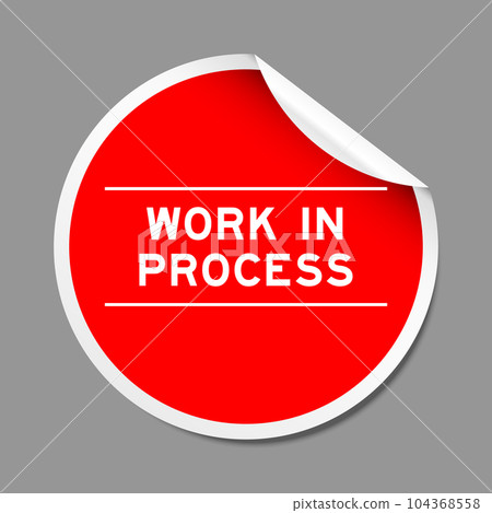 Red color peel sticker label with word work in process on gray background Red color peel sticker label with word work in process on gray background 104368558