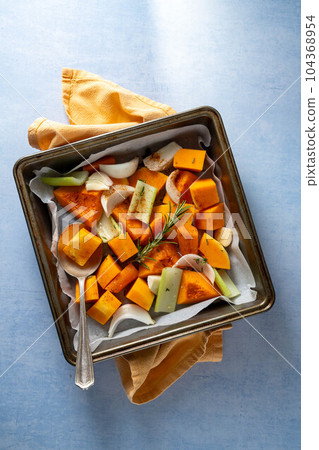 Pumpkin soup. Butternut squash and vegetables ready to be baked in baking tray. Pumpkin soup. Butternut squash and vegetables ready to be baked in baking tray. 104368954