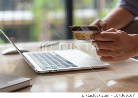 man hands holding credit card using internet payment laptop computer, online shopping digital banking, Business financial technology concept. man hands holding credit card using internet payment laptop computer, online shopping digital banking, Business financial technology concept. 104369167