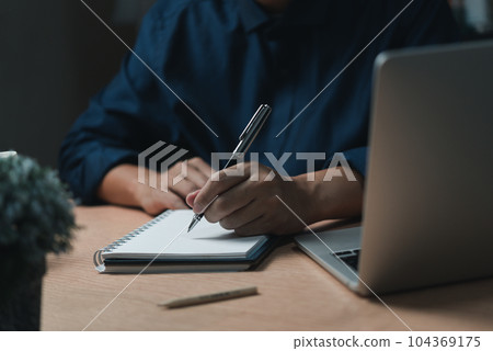 Businessperson reading and writing on book.education studying knowledge development and cognition learning concept. 104369175