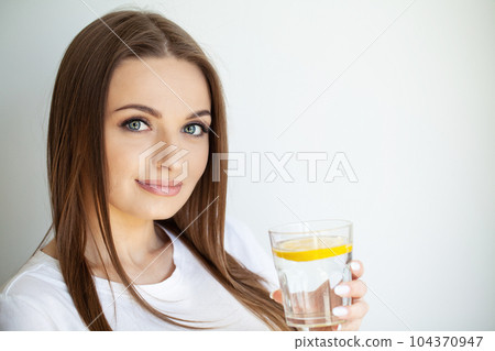 Woman Drinking Summer Refreshing Fruit Flavored Infused Water With Fresh Organic Lemon 104370947