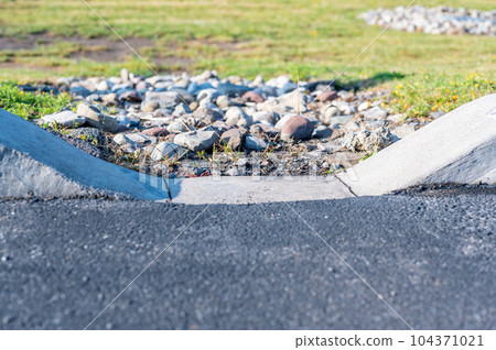 parking lot curbing cutout for stormwater drainage. parking lot curbing cutout for stormwater drainage. 104371021