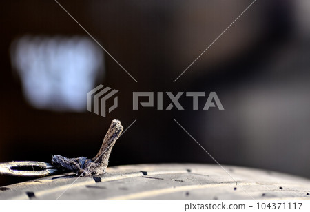 Repair plug being inserted to patch a nail tire puncture Repair plug being inserted to patch a nail tire puncture 104371117