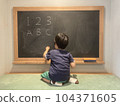 Children studying numbers and letters on the blackboard 104371605