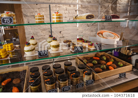 Cakes on the counter in a confectionery shop 104371618