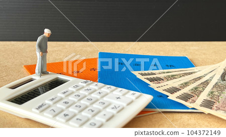 A miniature of an elderly man, a pension book, a calculator and money 104372149