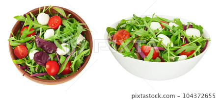 Mix salad - arugula, spinach, chard, cherry tomatoes and mozzarella in the bowl isolated on white background. Top view. Flat lay 104372655