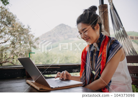 Tourist woman working online in the cafe while on traveling trip. 104373098