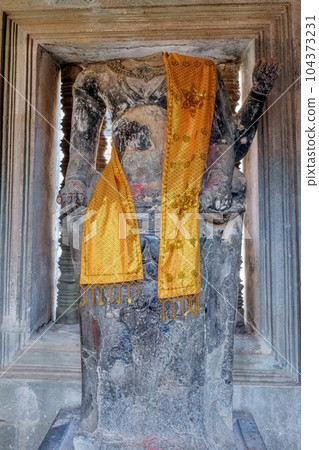 An ancient decapitated stone sculpture of Buddha in a Cambodian temple. An ancient decapitated stone sculpture of Buddha in a Cambodian temple. 104373231