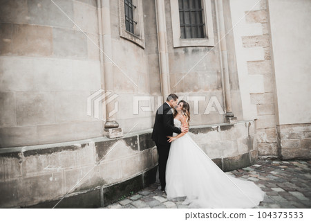 Lovely happy wedding couple, bride with long white dress Lovely happy wedding couple, bride with long white dress 104373533