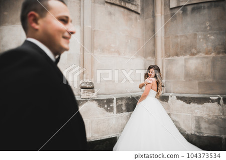 Lovely happy wedding couple, bride with long white dress Lovely happy wedding couple, bride with long white dress 104373534