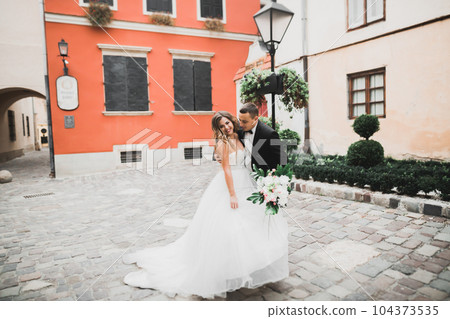 Lovely happy wedding couple, bride with long white dress Lovely happy wedding couple, bride with long white dress 104373535