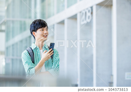 College student walking with smartphone College student walking with smartphone 104373813