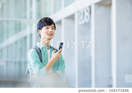 College student walking with smartphone College student walking with smartphone 104373886