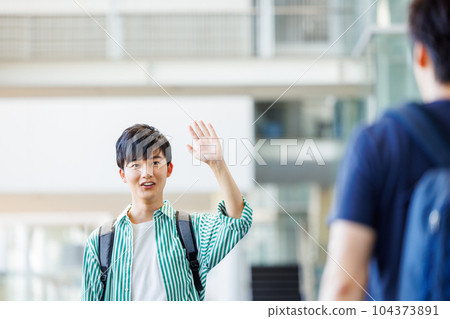 college student waving to friends 104373891