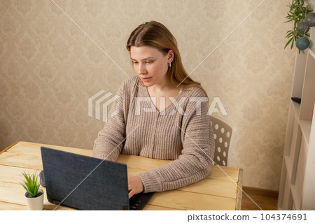 Woman using laptop computer networking. Young beautiful woman working Woman using laptop computer networking. Young beautiful woman working 104374691