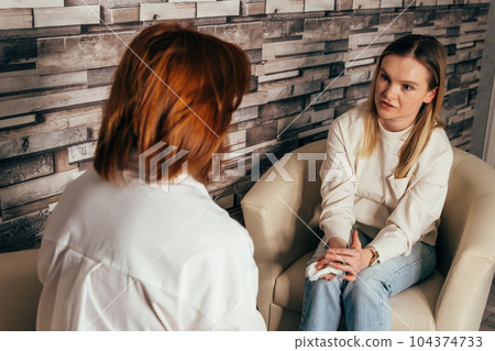 Therapist talk to his patient. Woman psychologist talking to patient. 104374733