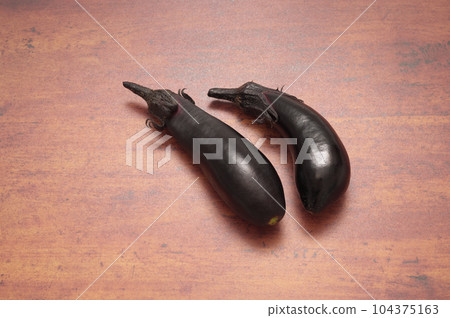 Summer vegetables (eggplant) Wooden table background 104375163